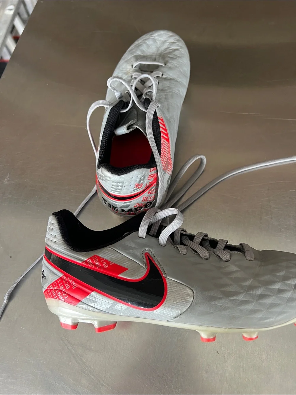 Nike Youth Gray Soccer Cleats with Black Swoosh and Pink-Red Accents